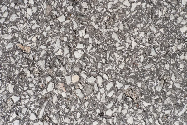 Old asphalt road with big grain stones. — Stock Photo, Image