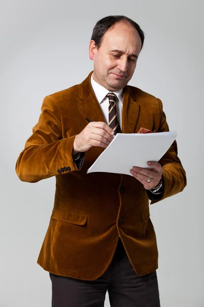Mature Man Signing a Document — Stock Photo, Image