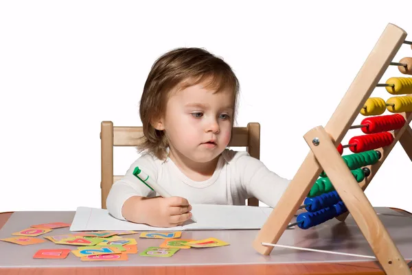 Little girl playing with toy abacus and learns to count — Stock Photo, Image