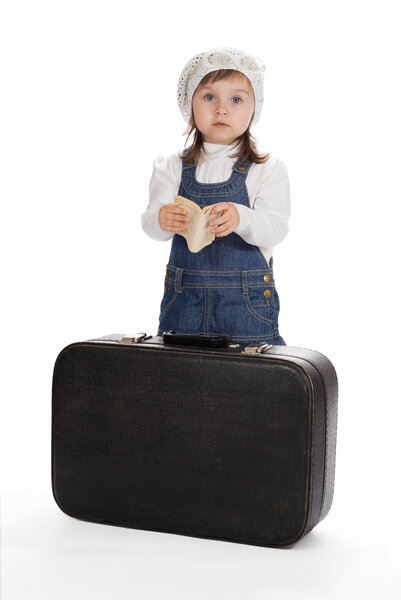 Pretty little girl with book and suitcase