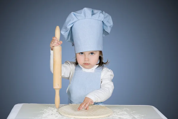 Beautiful little girl masrer chief cooking pizza — Stock Photo, Image