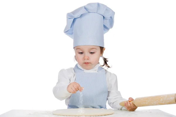 Beautiful little girl sprinkle with flour pizza — Stock Photo, Image