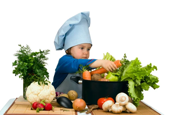 Cute little girl cooking soup with lots of different vegetables — Stock Photo, Image