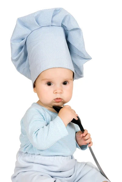 Niño pequeño con cucharón de metal y sombrero de cocinero — Foto de Stock