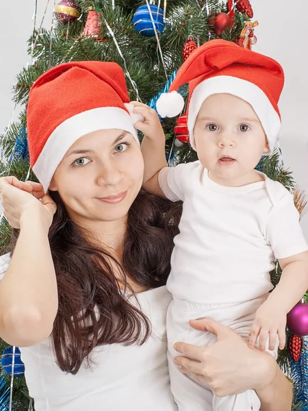 Mom and kid at Christmas tree.