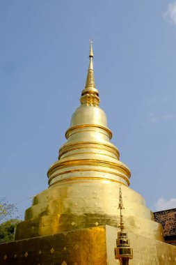 The gold pagoda in Wat Phra Sing Waramahavihan temple. Phrae province, Thailand.