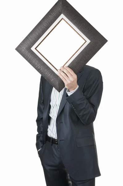 Businessman holding empty frame — Stock Photo, Image