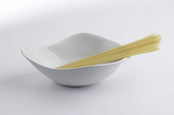 Bol en porcelaine blanche et pâtes spaghetti — Photo