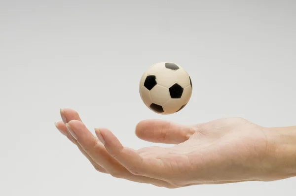 Soccer ball on female hand — Stock Photo, Image
