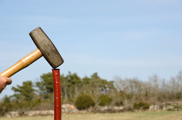 Sledgehammer at a pole — Stock Photo, Image