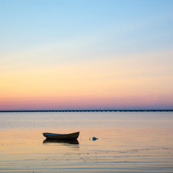 Anchored rowboat at sunset — Stock Photo, Image