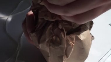 A young girl hands opens a parcel contains a gift. Surprise. People, delivery, shipping service, opening parcel at home