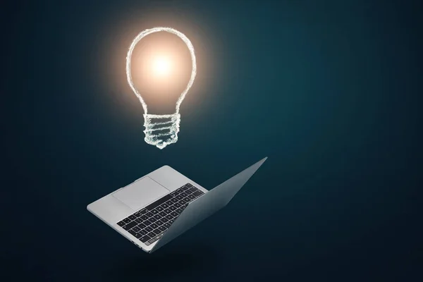 Idea concept. Creative light bulb under modern laptop. Copy space.