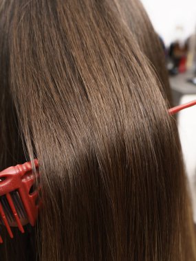 Hair coloring women close up texture background. Bunch of shiny straight blond hair in a wavy curved style. Copy space