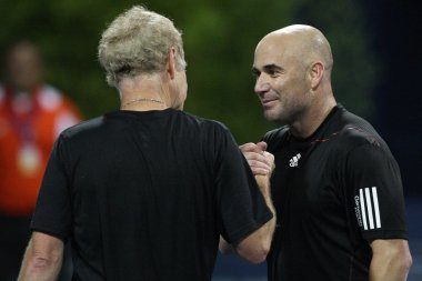 Andre Agassi and John McEnroe play a charity match clipart