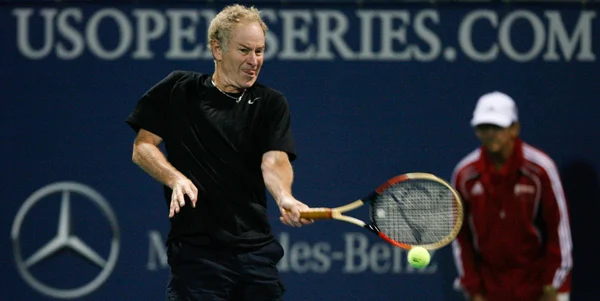 Andre Agassi and John McEnroe play a charity match — Stock Photo, Image