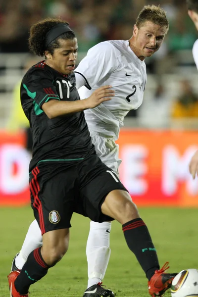 在比赛中球 giovani dos 多斯桑托斯和 ben sigmund 战役 — 图库照片
