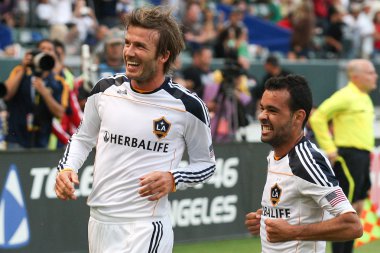 David Beckham and Juninho celebrate Beckhams goal during the game