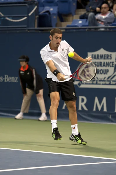 Flavio Cipolla backhands a return to Jack Sock during the tennis match — Stock Photo, Image