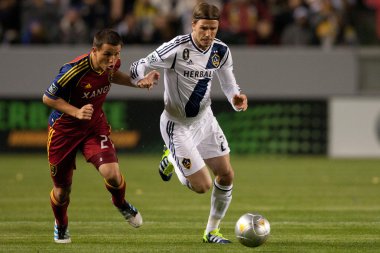 Luis Gil and David Beckham fight for the ball during the Major League Soccer game