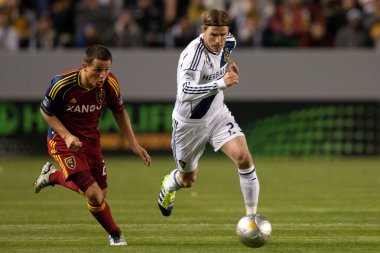 Luis Gil and David Beckham fight for the ball during the Major League Soccer game