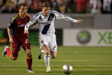 Luis Gil and David Beckham fight for the ball during the Major League Soccer game