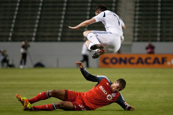 Ryan Johnson slides into a jumping Robbie Keane during the game — Stock Photo, Image