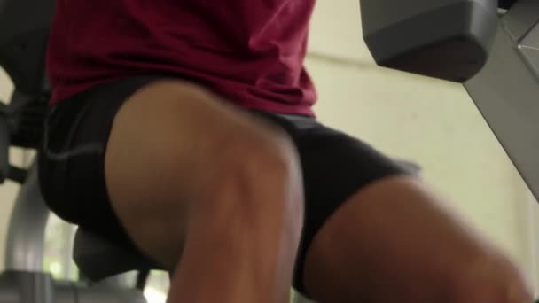 Un joven guapo está haciendo ejercicio en el gimnasio. — Vídeo de stock