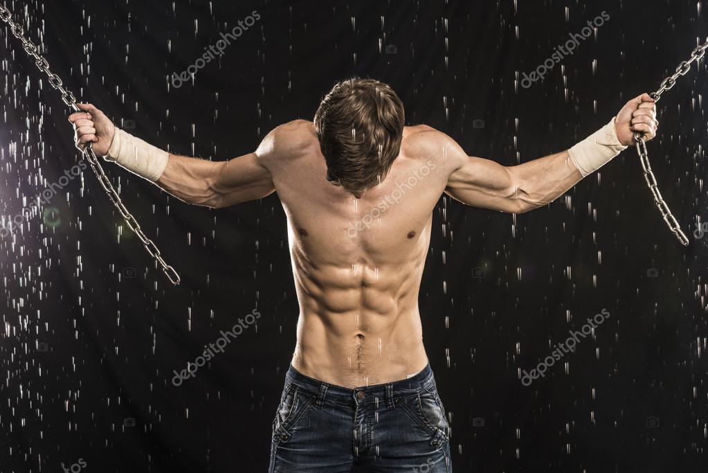 Image of muscle man with chains posing in water studio — Stock Photo