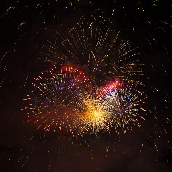 Colorful fireworks of various colors over night sky — Stock Photo, Image