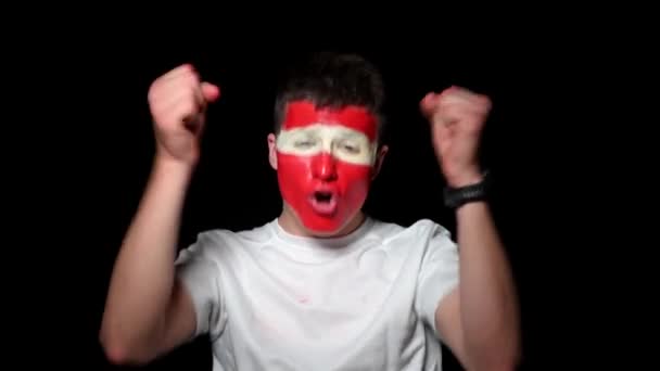 Happy fan celebrate victory of his team. Young man with face painted in national colours. Portrait of a happy man supports his national team at home — Stock Video