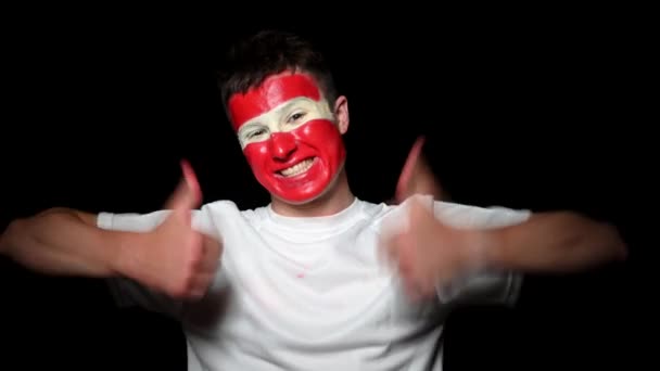 Happy fan celebrate victory of his team. Young man with face painted in national colours. Portrait of a happy man supports his national team at home — Stock Video