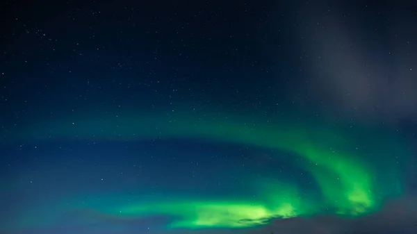 Northern Lights also known as aurora, borealis or polar lights at cold night over deep black star sky. Beautiful night photo of magic nature phenomenon — Stock Photo, Image