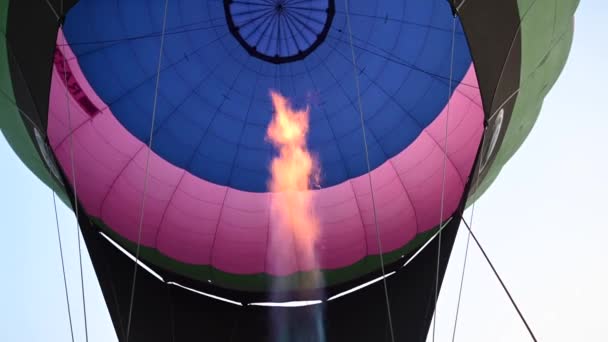 Hot air balloons open festival, balloons of different colours fly over rocky mountains, balloons flying on sunset over cloudy sky, 4k HDR cinematic footage — Stok video