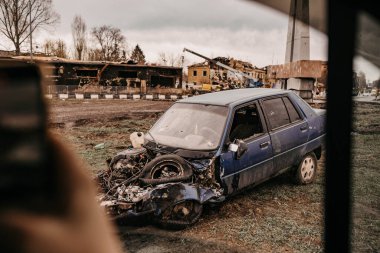 Borodyanka, Kyiv region, Ukraine. April 08, 2022: twisted wreckage of car being destroyed by russian army  clipart