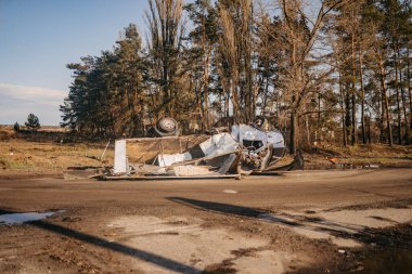 Borodyanka, Kyiv region, Ukraine. April 08, 2022: twisted wreckage of car being destroyed by russian army  clipart