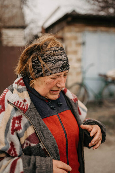 Borodyanka, Kyiv region, Ukraine. April 08, 2022: Senior woman in liberated village Borodynka