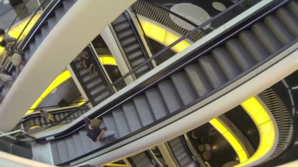 Young man with mobile phone on the escalator. — Stock Video