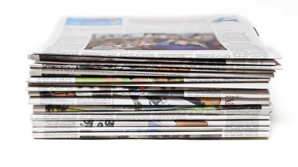 Pile of old newspapers on a white — Stock Photo, Image