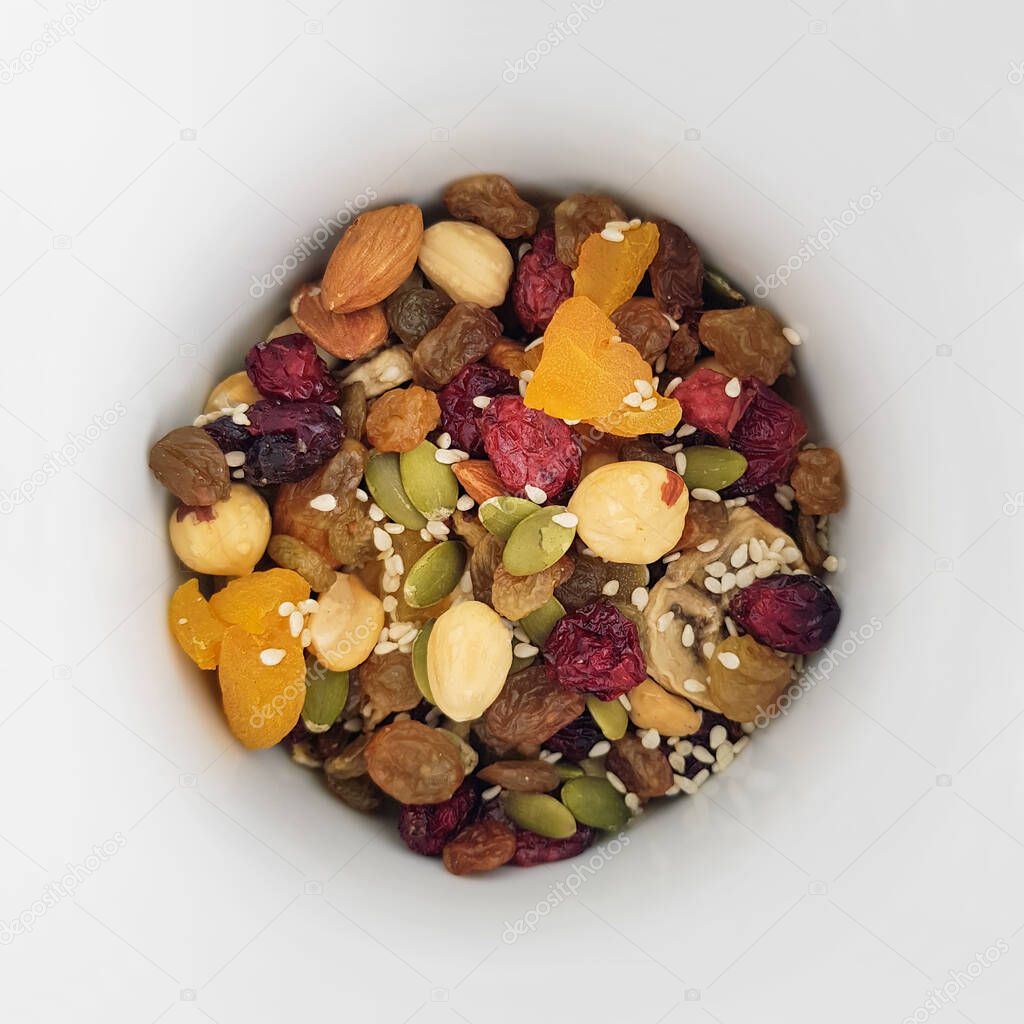 a handful of a mixture of natural fruits and grains, muesli, natural breakfast, healthy food