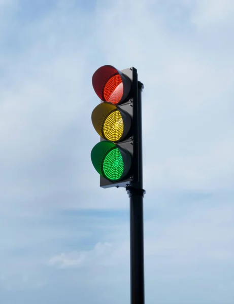 traffic light with red, yellow and green colors on isolated on blue sky background. Mock-up or source. 3d render