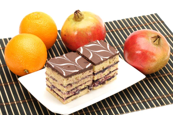 Orange,Pomegranate and tasty cake isolated on white background — Stock Photo, Image