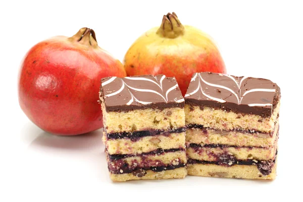 Pomegranate and tasty cake isolated on white background — Stock Photo, Image
