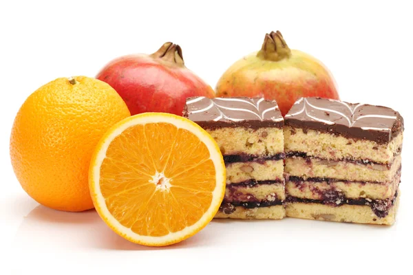 Orange,Pomegranate and tasty cake isolated on white background — Stock Photo, Image