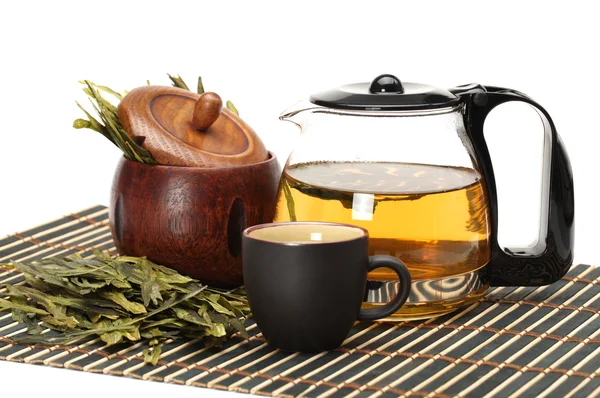 Чашка и чайник с чаем на белом фоне — стоковое фото