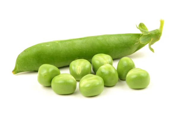 Green peas on the white background — Stock Photo, Image