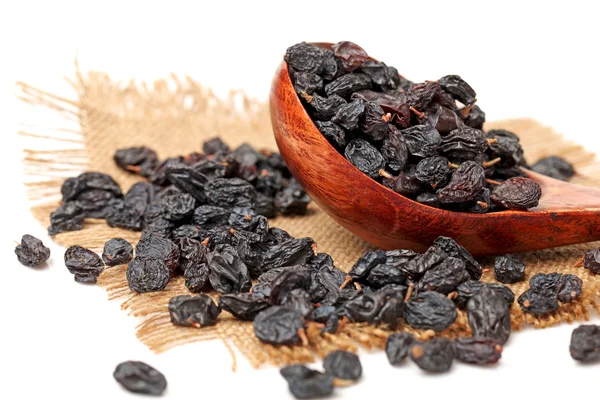 Black raisins on a white background — Stock Photo, Image