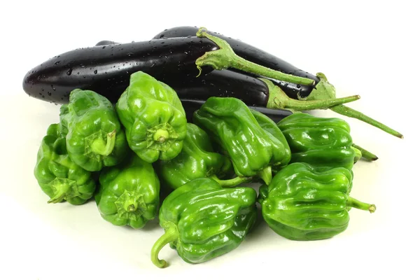 Green peppers and purple eggplant — Stock Photo, Image