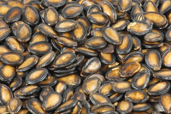 Nasiona melona czarne tło — Zdjęcie stockowe