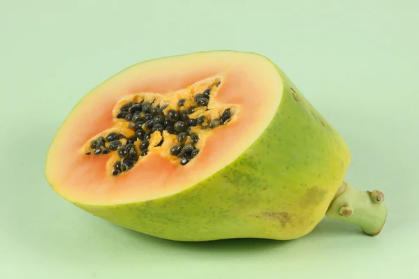 Papaya fruit sliced on half isolated on a green background. — Stock Photo, Image